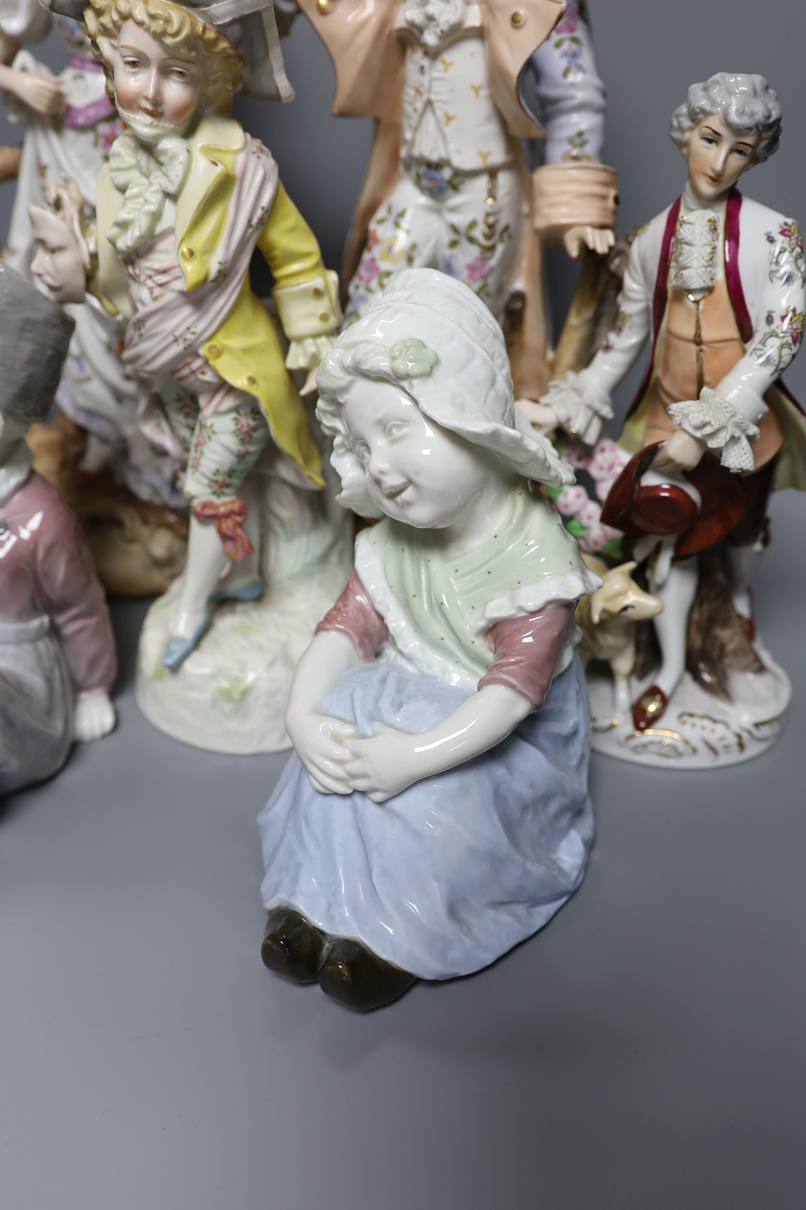 A collection of German and French porcelain figurines, tallest 39.5cm high